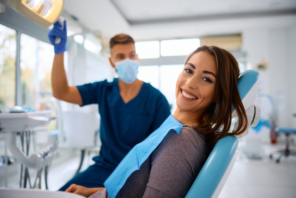 Smiling woman showcasing her bright smile after dental crown treatment.